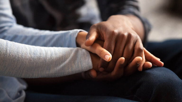 Newlyweds holding each other hands giving advice and comfort