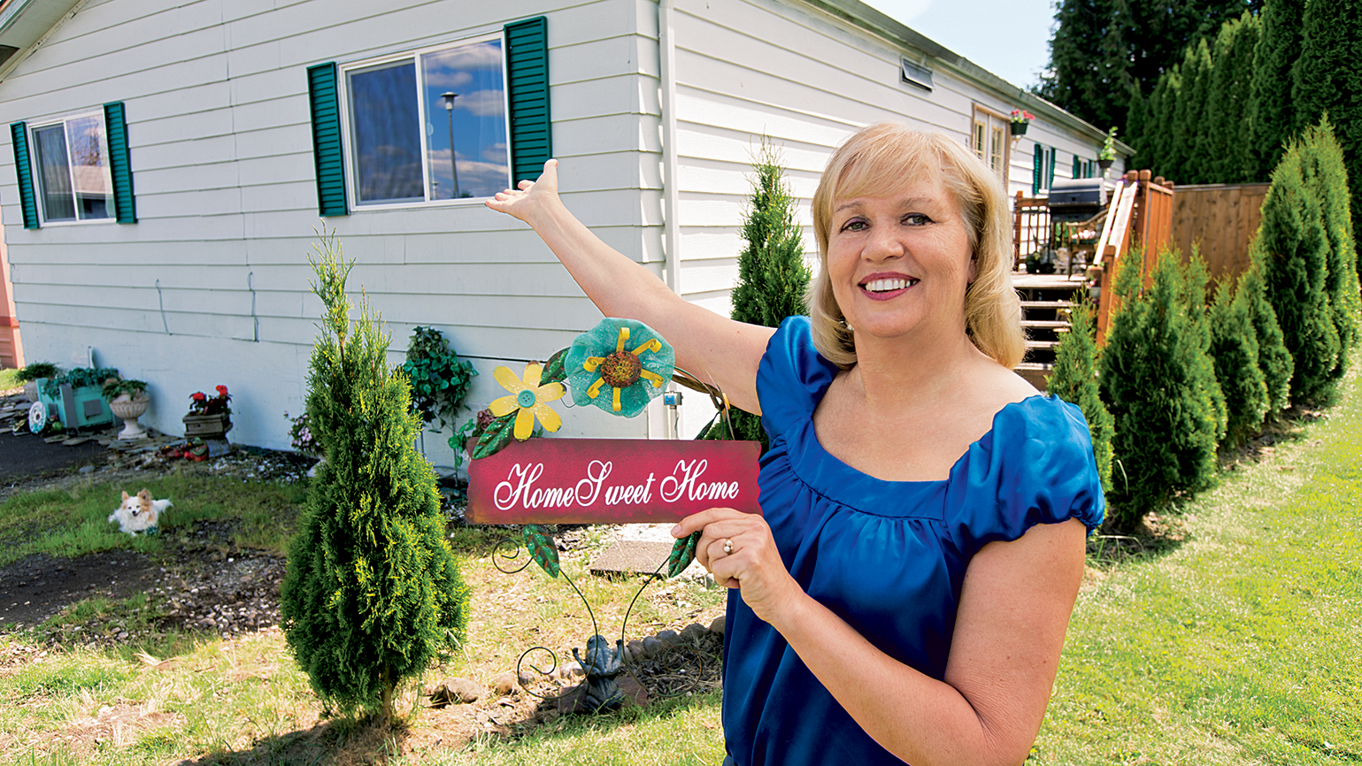 Barbara McCourtney outside her new home; photo by Randy Boverman
