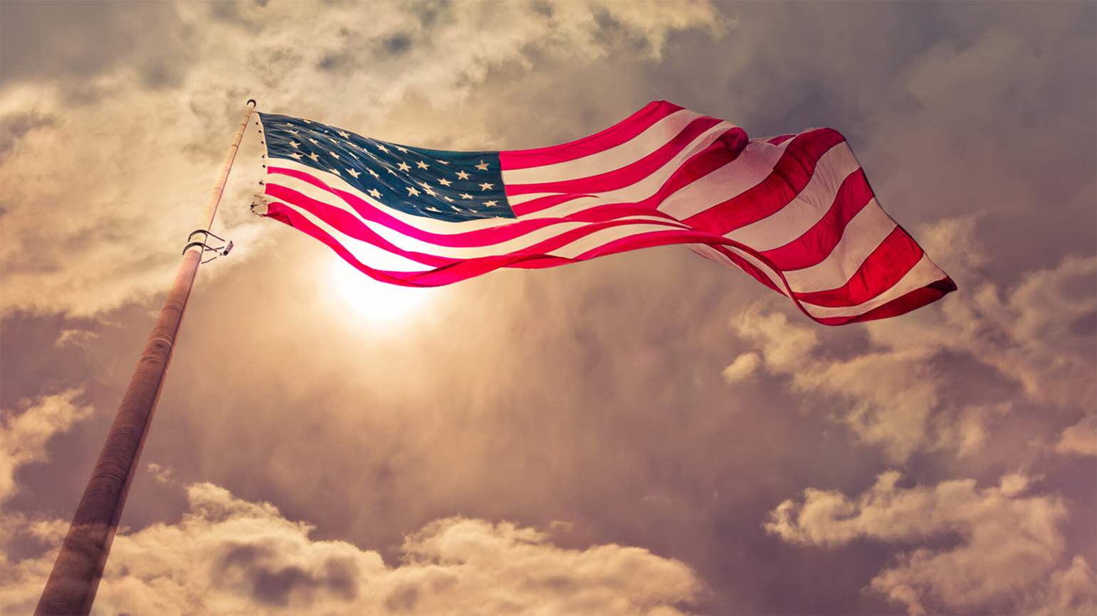 An American flag waves in the breeze; Getty Images