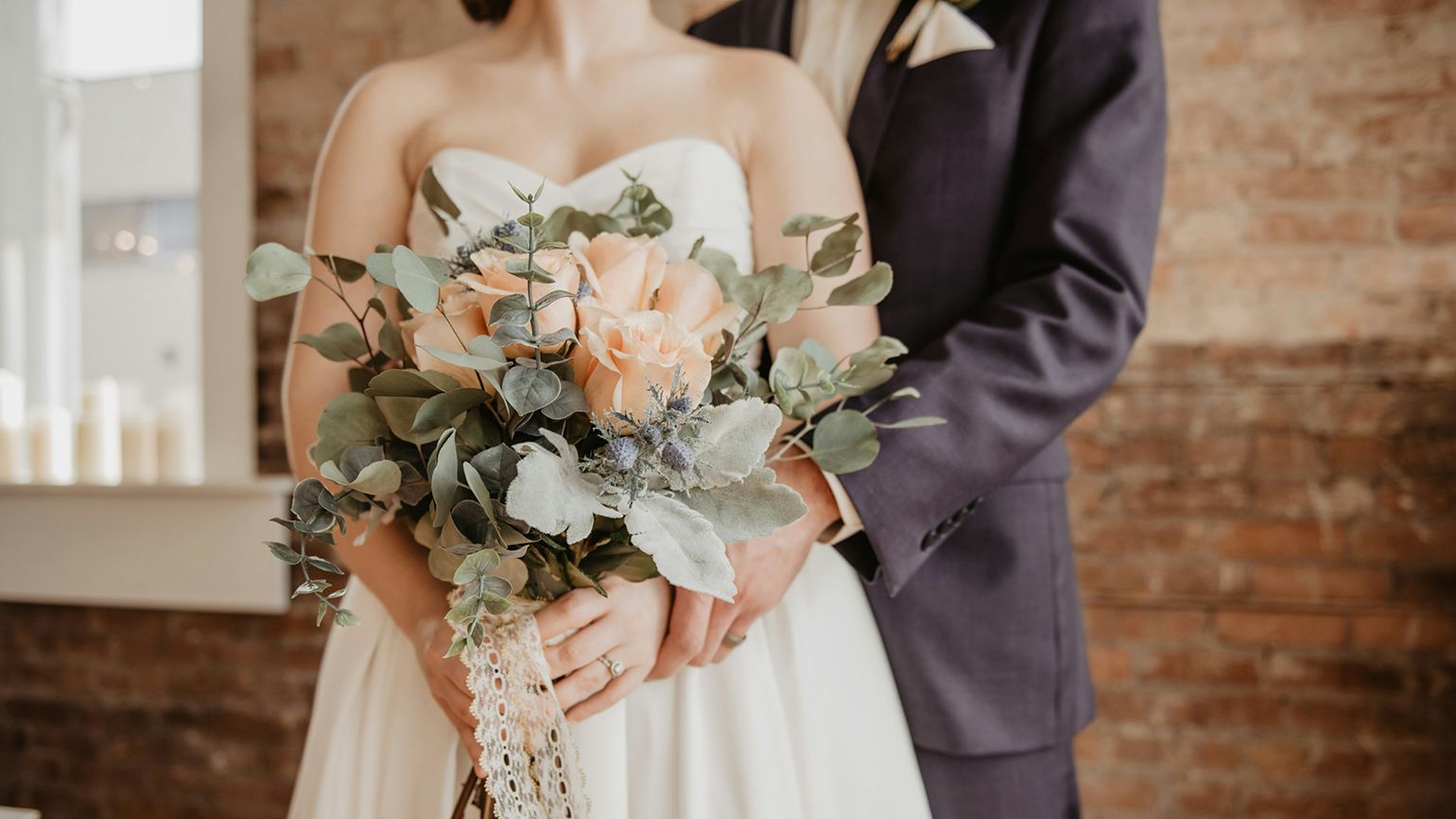 A bride and groom on their wedding day; Olivia Bauso/Unsplash
