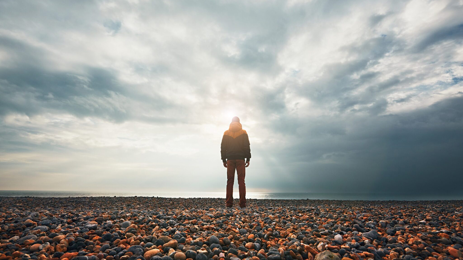 Silhouette of a figure alone on the beach; Getty Images
