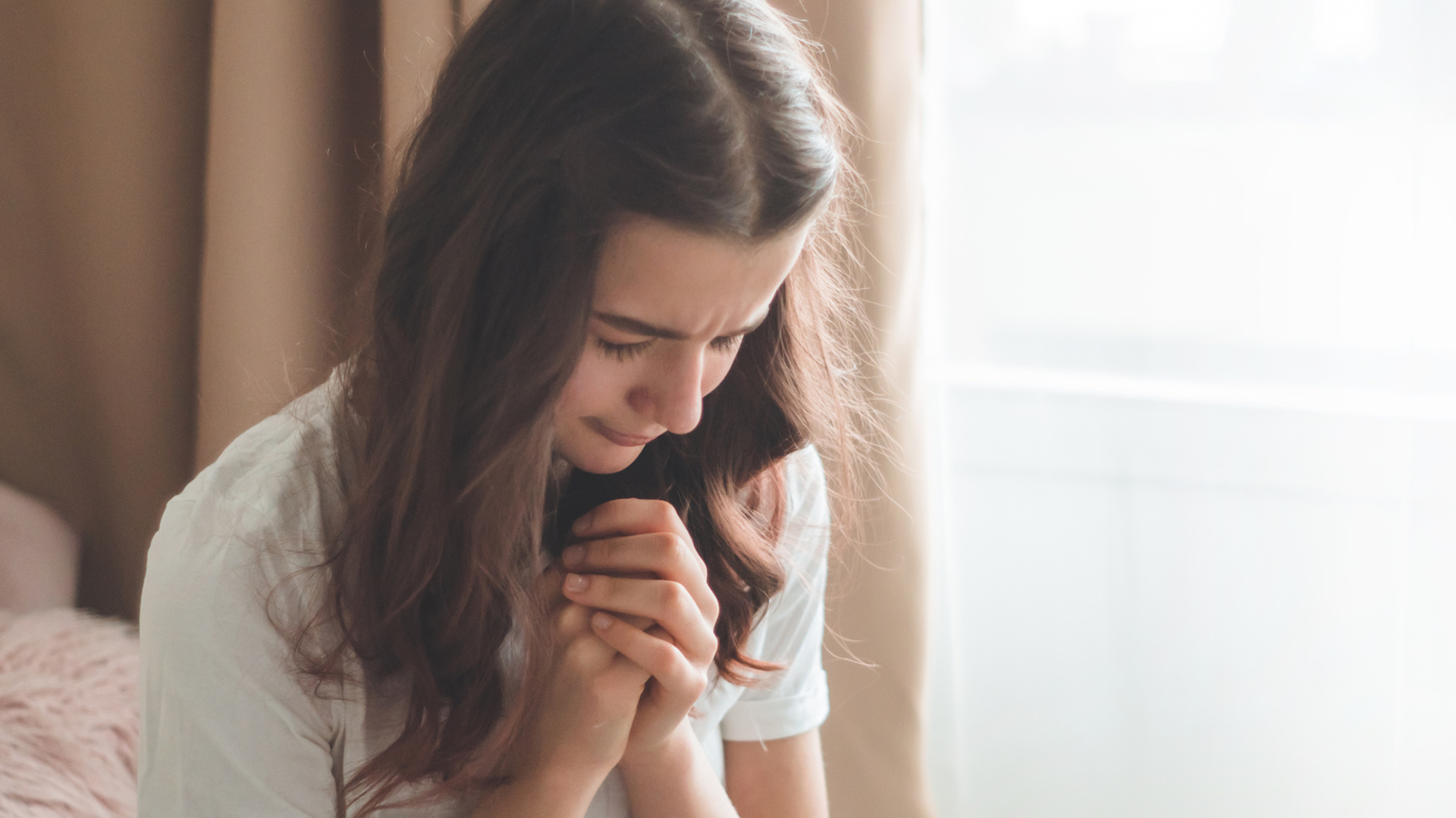 A teenage girl prays