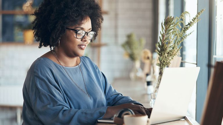 A roytalty-free image: A woman writing at her computer; Getty Images