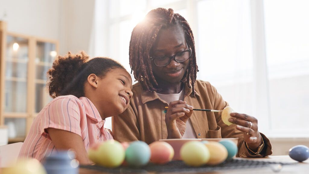 A mother and daughter dye Easter eggs; Getty Images