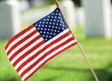 An American flag in a cemetery