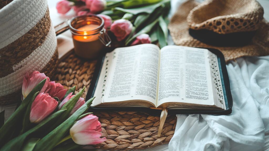 An open Bible with spring flowers; Getty Images
