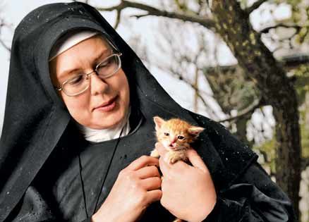 Sr. Michael Marie with tiny kitten. She practices her faith by rescuing animals.