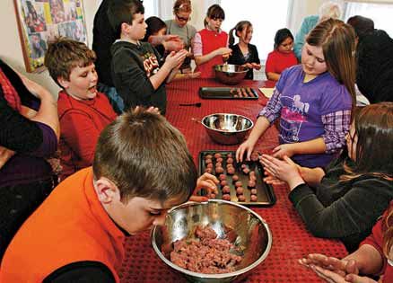 A retiree shares her faith by inspiring a group of children to learn to cook.