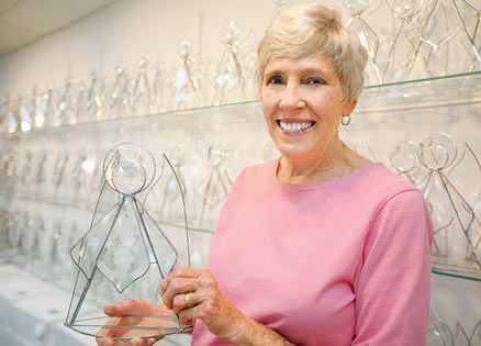 Bobbie Burnett with the stained glass angels that bring hope to cancer patients.