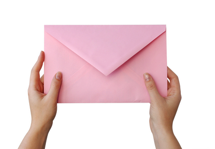 A woman's hands holding a large pink envelope