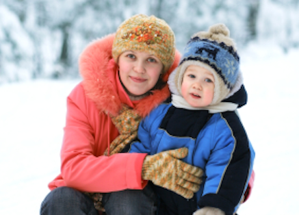 smiling woman and son in the snow, happy despite tough times