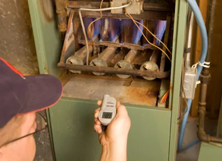 Service man fixing a gas furnace.