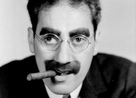 Groucho Marx with a cigar in his mouth