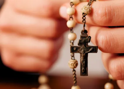 Hands holding a rosary