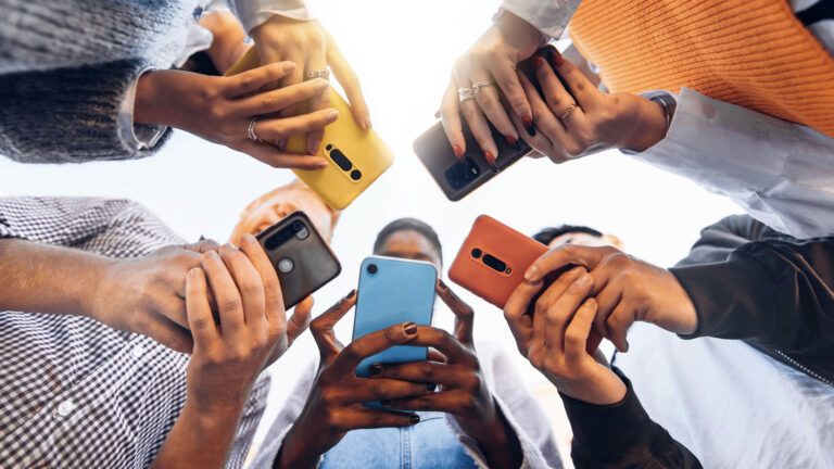 A group of friends holding up colorful cellphones to give up social media for lent