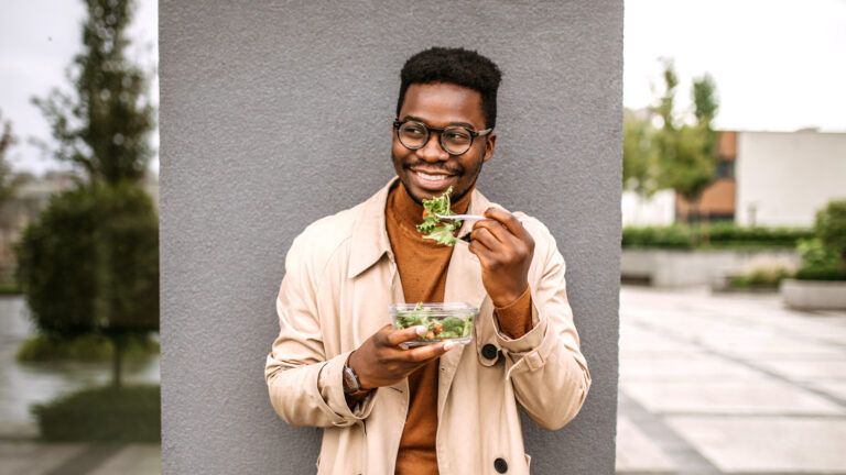 Man outside eating a salad to give up unhealthy things for lent