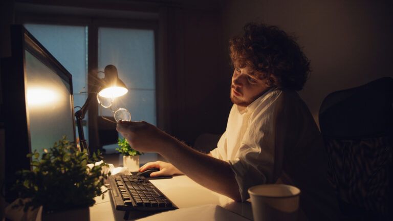 Man sitting at his desk late at night to give something up for lent