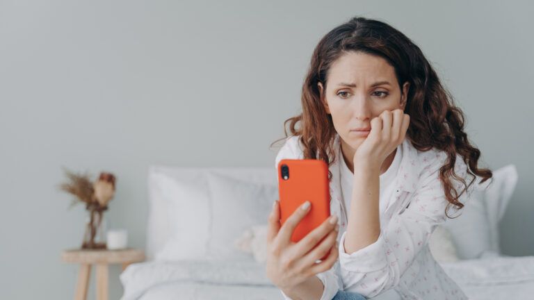 Woman looking at her phone to give up doomscrolling for lent