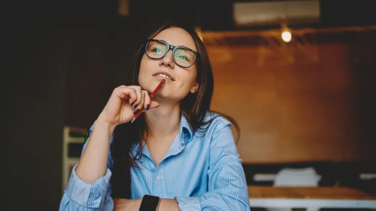 Woman with a pen thinking about what to give up for lent