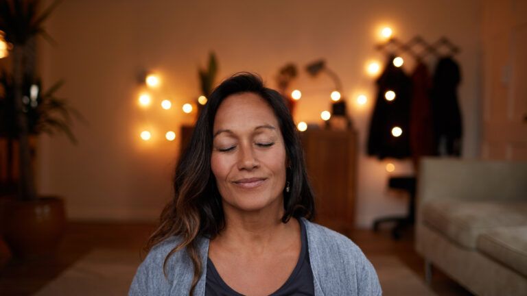 Woman with her eyes closed meditating to give up something for lent