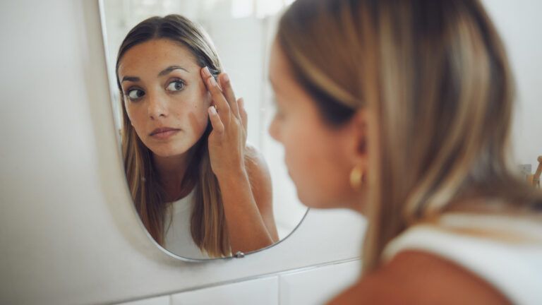 woman looking in mirror to give up self criticism for lent
