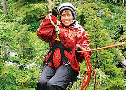 Susan Karas zip-lines above the trees in Alaska
