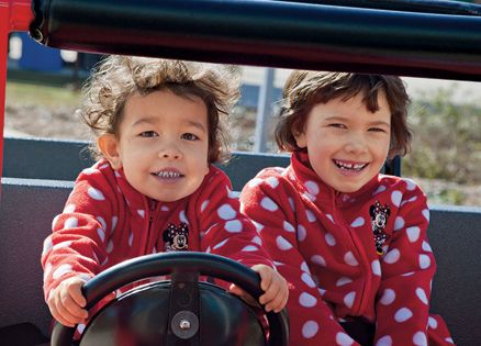 A pair of happy children enjoy a ride at Morgan's Wonderland