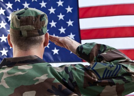 Guideposts: A soldier in fatigues salutes the flag.