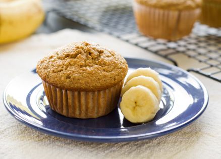 Banana muffin with banana slices beside it