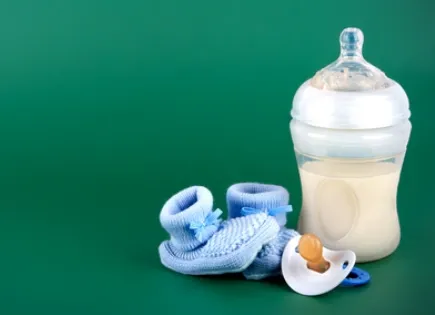 baby bottle, blue booties and binkie