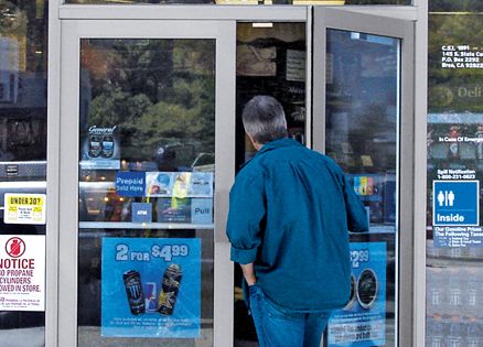 A man at the door of a convenience store