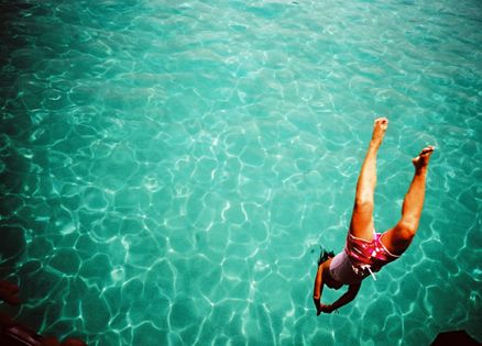 A woman diving into beautiful water -- an image of positivity