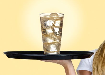 A server's tray with a lone glass of ginger ale on it