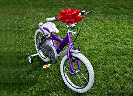 A girl's bike with a large red bow