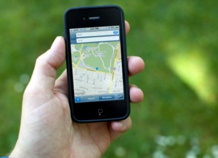 person consulting iphone for map app