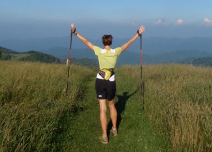 Jennifer Pharr Davis joyously raises her arms while hiking the Appalachian Trail