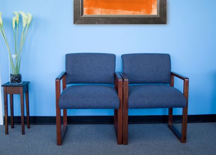 A doctor's waiting room with an abstract painting on the wall