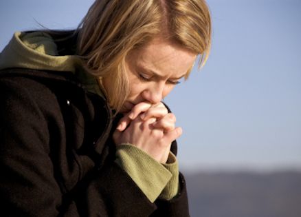 woman deep in prayer