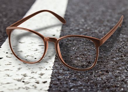 Eyeglasses on an asphalt surface