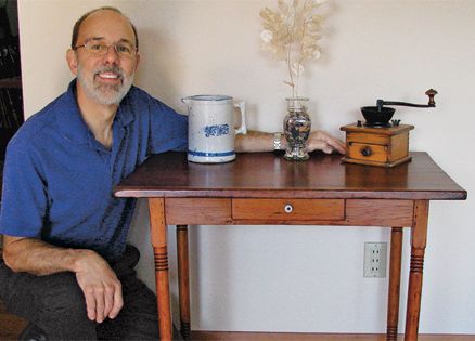 Garry Zalesky poses with his restored table.