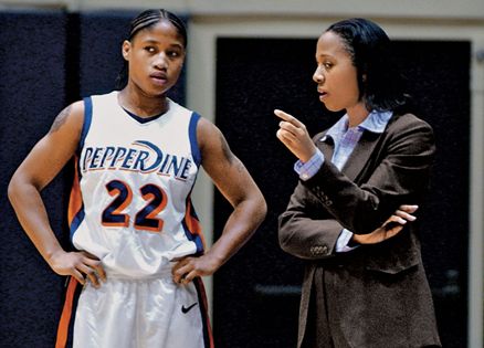 Coach Rousseau offers guidance to one of her Pepperdine players.