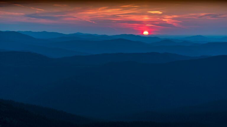 The sun setting over a mountain range.