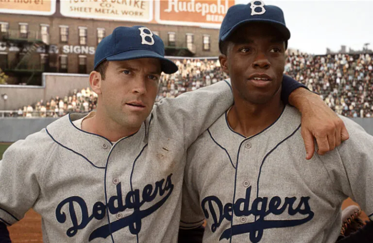 Pee-Wee Reese (Lucas Black) embraces Jackie Robinson (Chadwick Boseman)