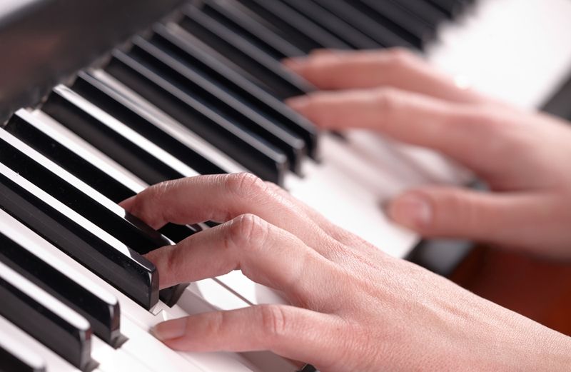 Woman's hands on a piano keyboard