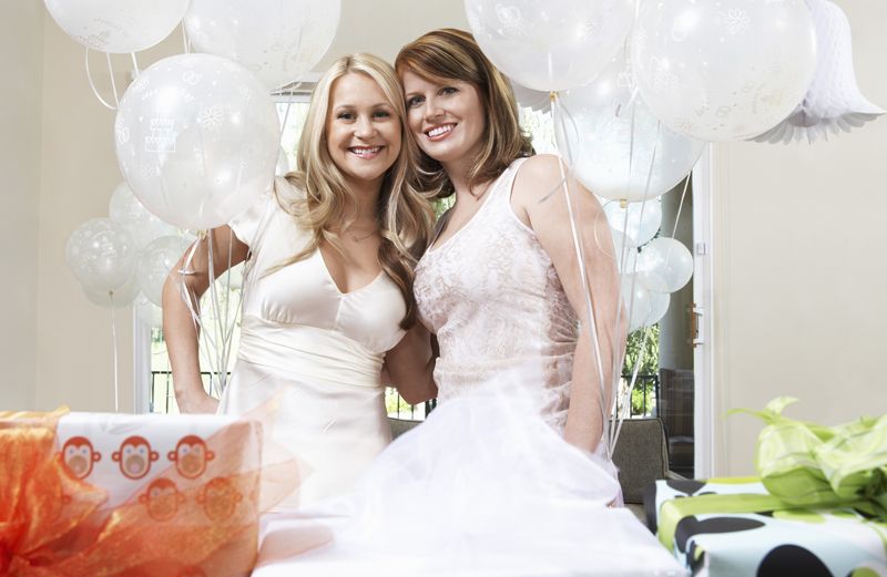 Two smiling women pose for a photo at a bridal shower.