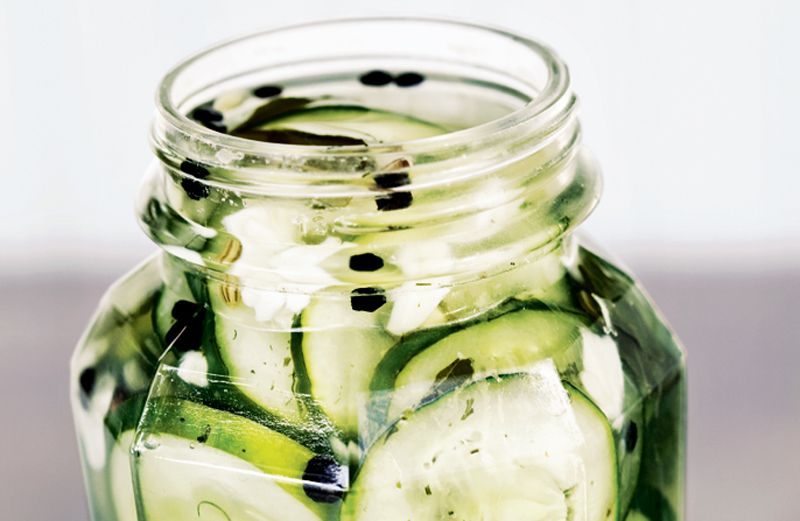 An open jar of Emeril Legasse's Kosher-Style Dill Pickles