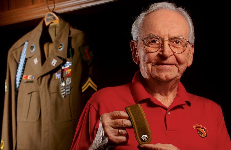 Roy Shull displays the shoulder patch Alois Wagner gave him.