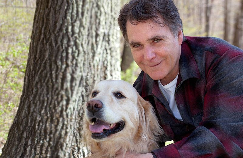 Guideposts Editor-in-Chief Edward Grinnan and his dog Millie hiking in the woods