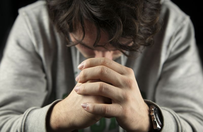 A man bowing his head in prayer
