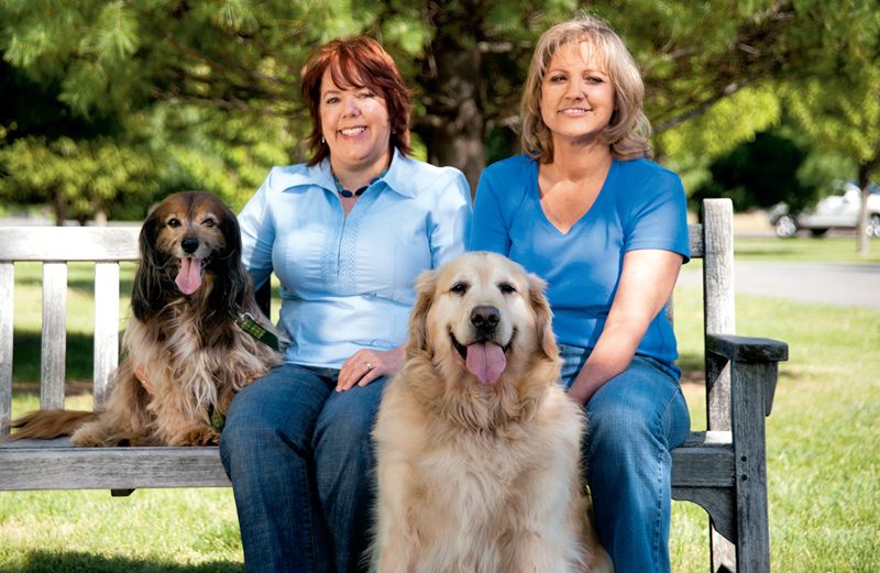 Peggy Frezon with her spaniel, Kelly, and Kathy with her golden, Moses